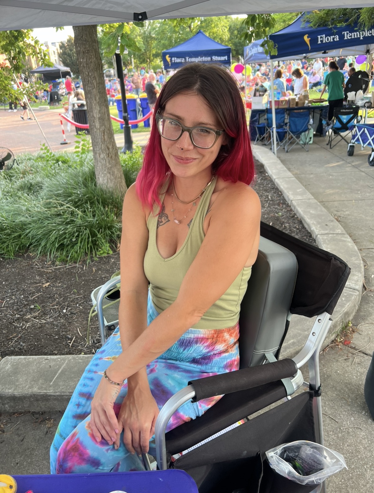 Sadie sitting at an outdoor event, ready to paint