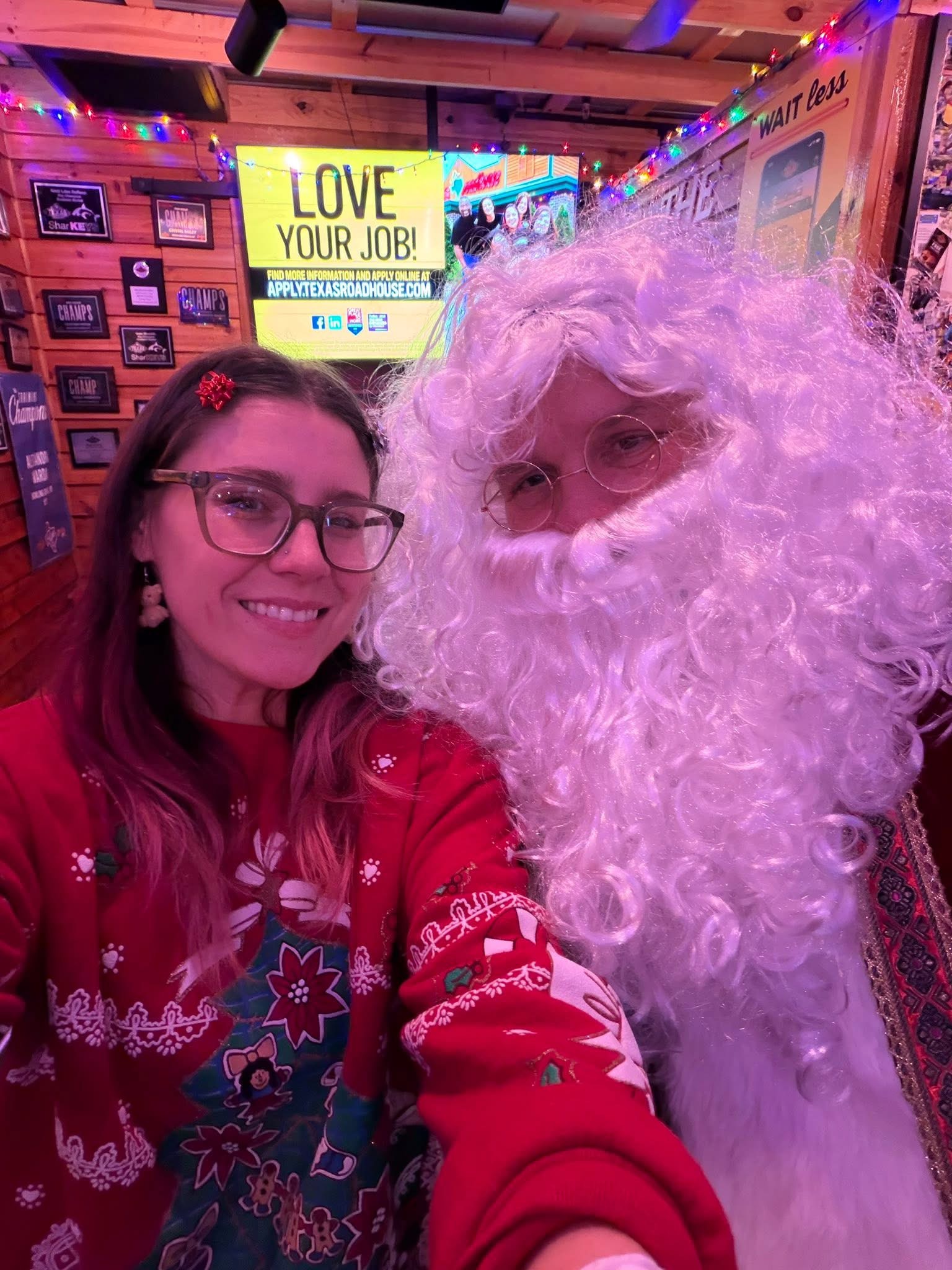 Sadie posing with Santa at a Christmas event